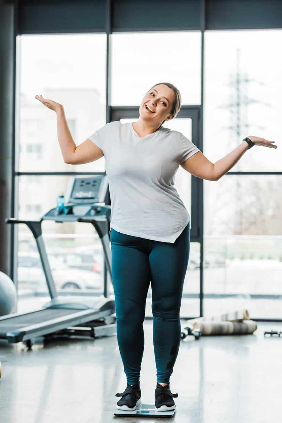 Happy woman at the gym.  Working out can give you better results with intermittent fasting.  