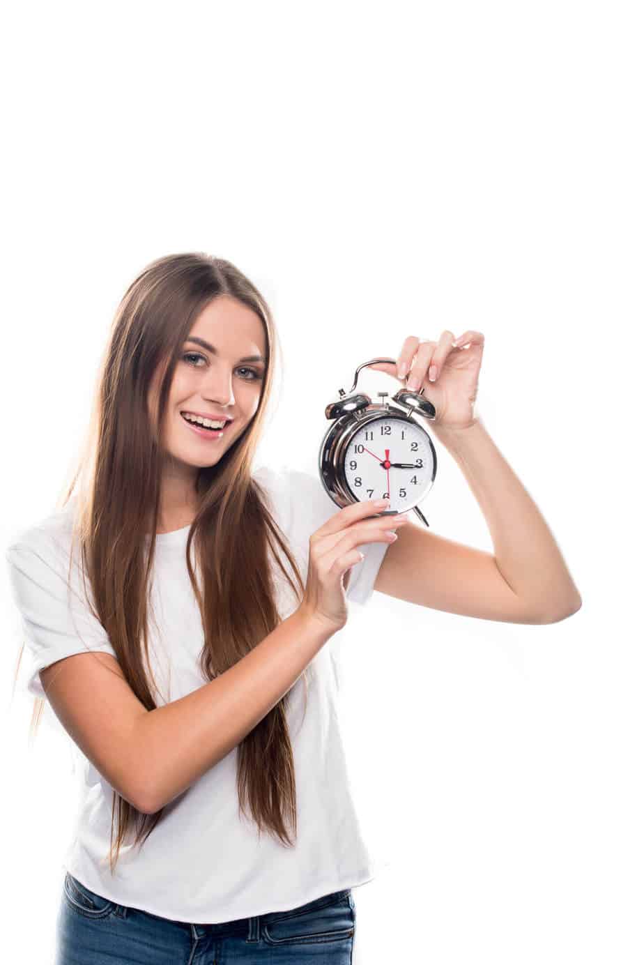 Woman holding a clock.  Check your intermittent fasting window to make sure you're fasting long enough for results.  